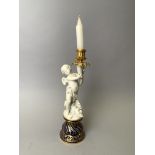 SEVRES. Flambeau en biscuit, porcelaine et bronze doré. H. 31 cm. -