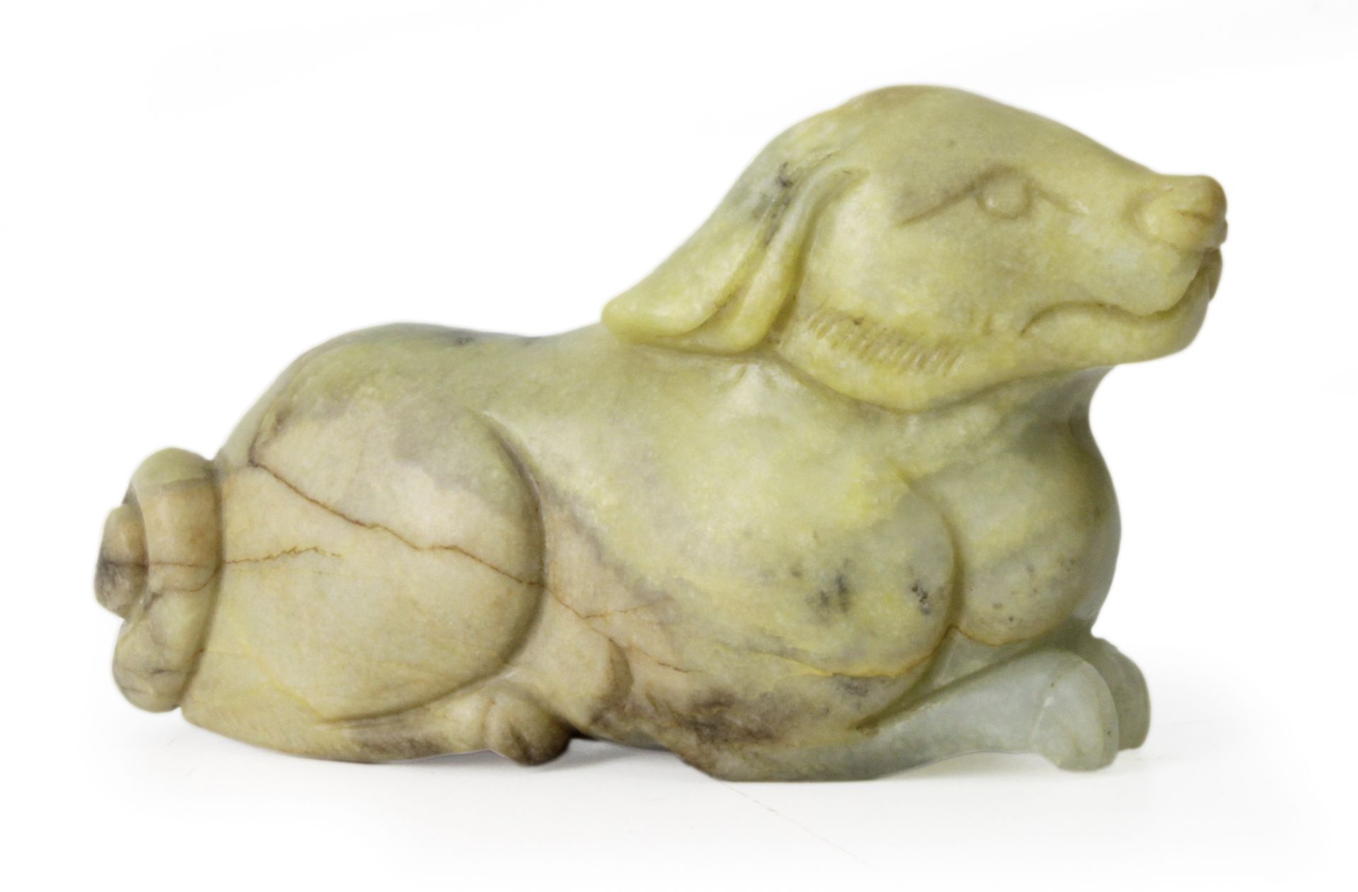 A 20th century Chinese school. Carved jade dog figure