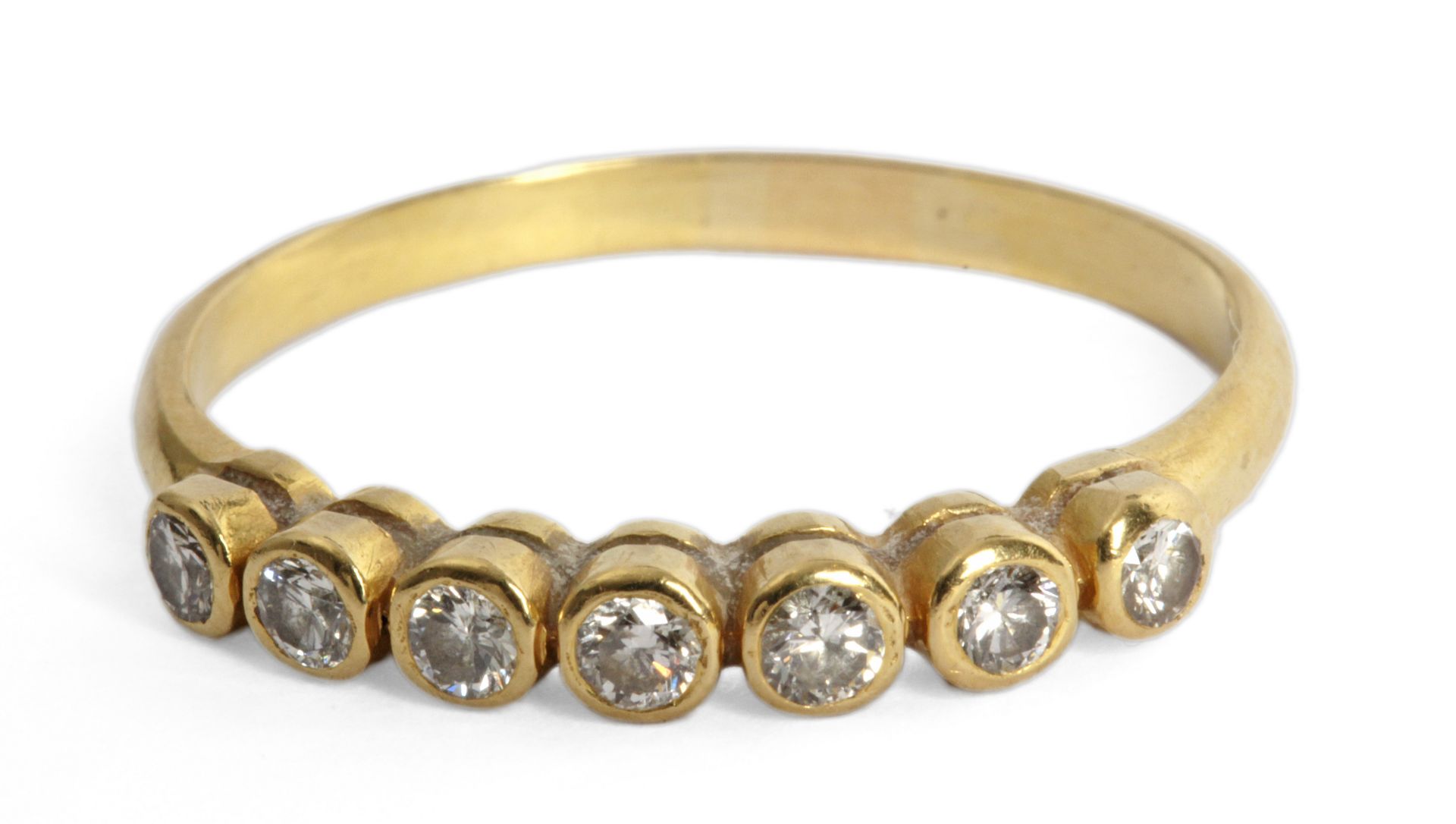Diamond half eternity ring with an 18k. yellow gold setting