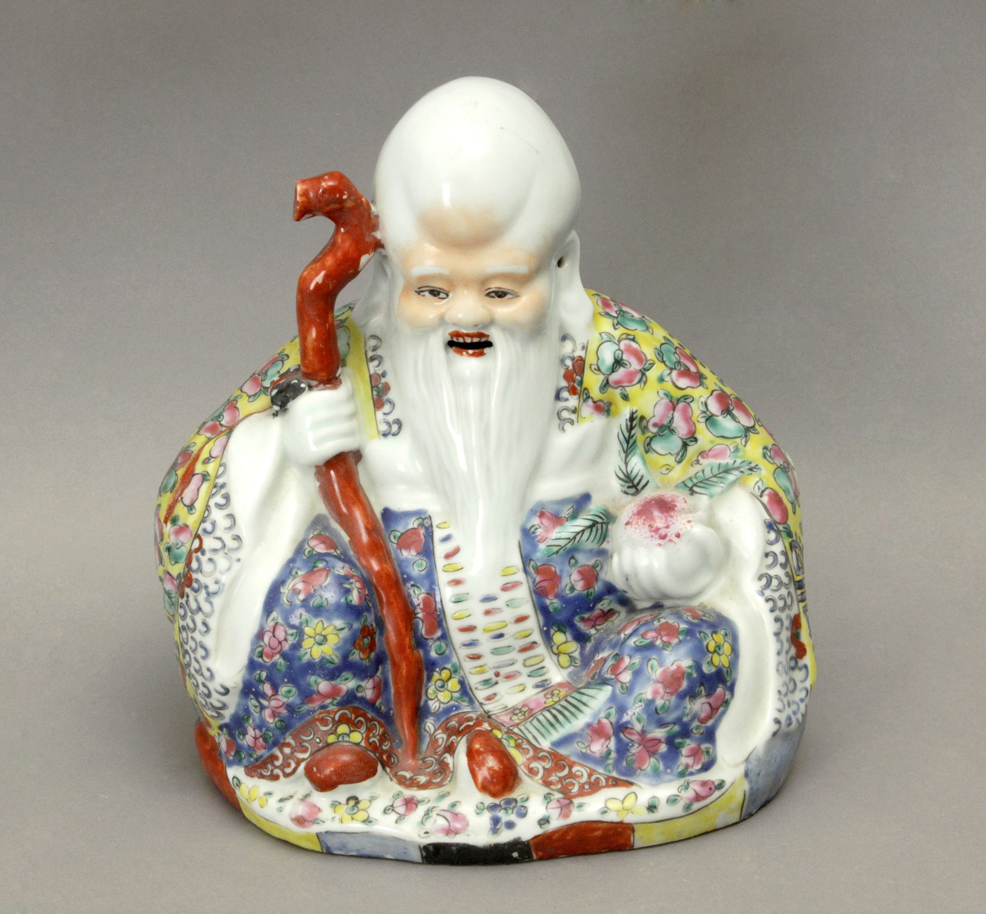 20th century Chinese school. A polychromed porcelain Buddha figure