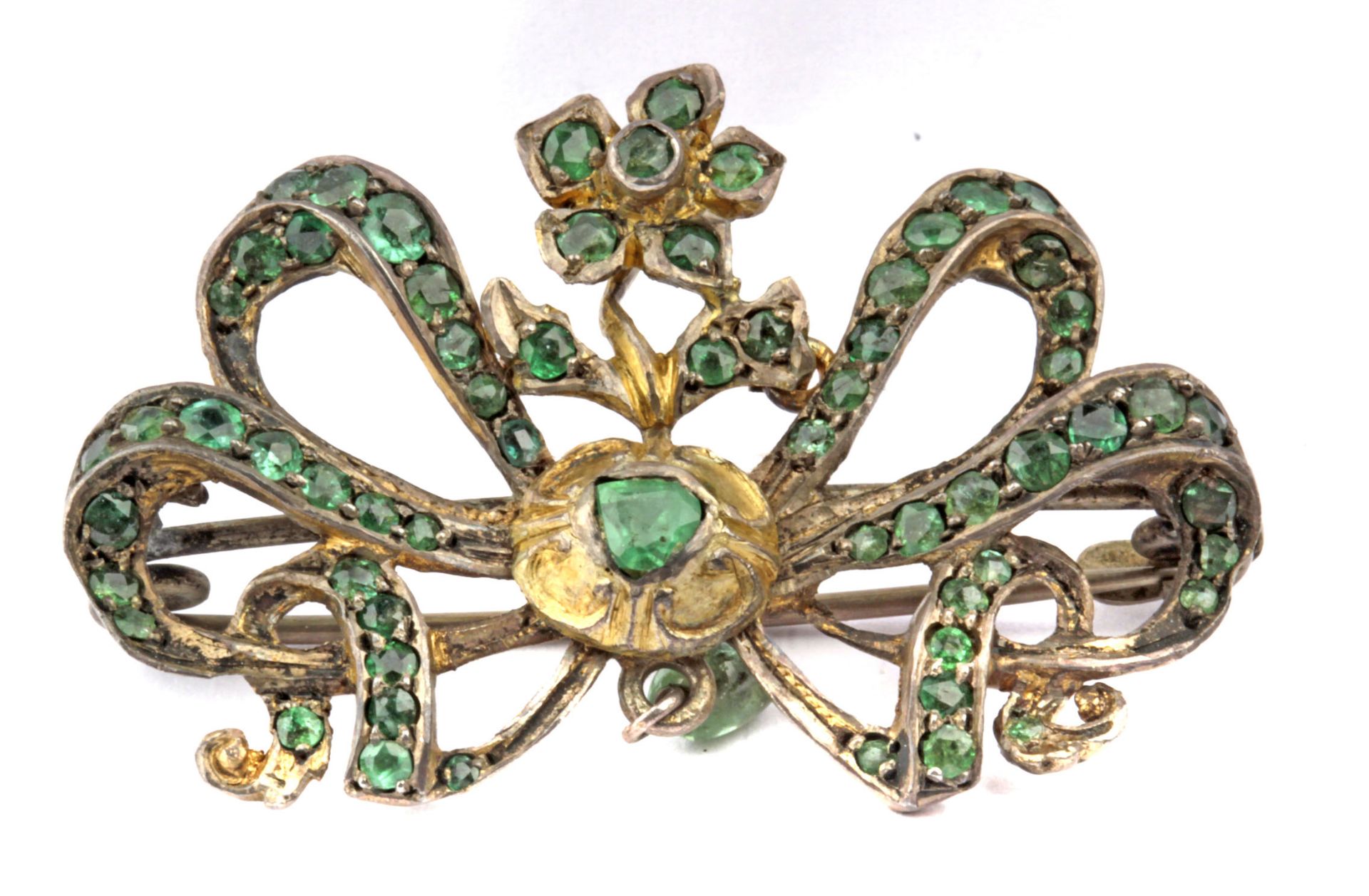 Late 19th century brooch with a silver setting and emeralds