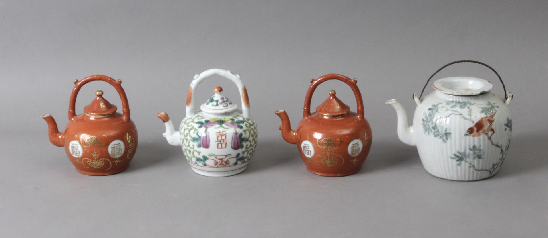 Four 20th century Chinese teapots in porcelain