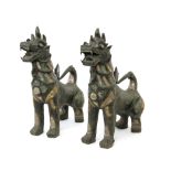 A pair of first half of 20th century Cambodian bronze guardian lions sculptures
