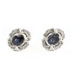 18k. white gold, brilliant cut diamonds and oval cut sapphire cluster earrings