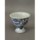 A 19th century Chinese Qing dinasty libation cup in white and blue porcelain