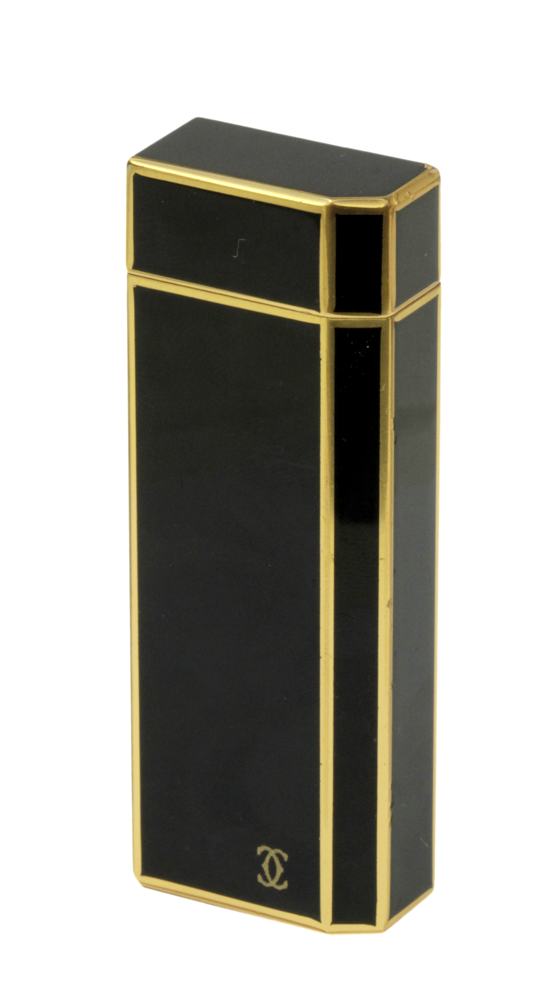 Cartier. Lighter in black lacquer and gold plated metal