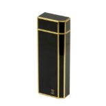 Cartier. Lighter in black lacquer and gold plated metal