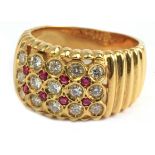 An 18 k. yellow gold ring with round brilliant cut diamonds and single cut rubies