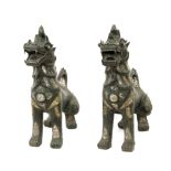 A pair of first half of 20th century Cambodian bronze guardian lions sculptures
