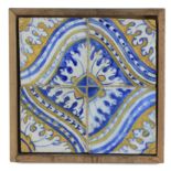 An 18th century plaque with four showing tiles from Portugal or Talavera