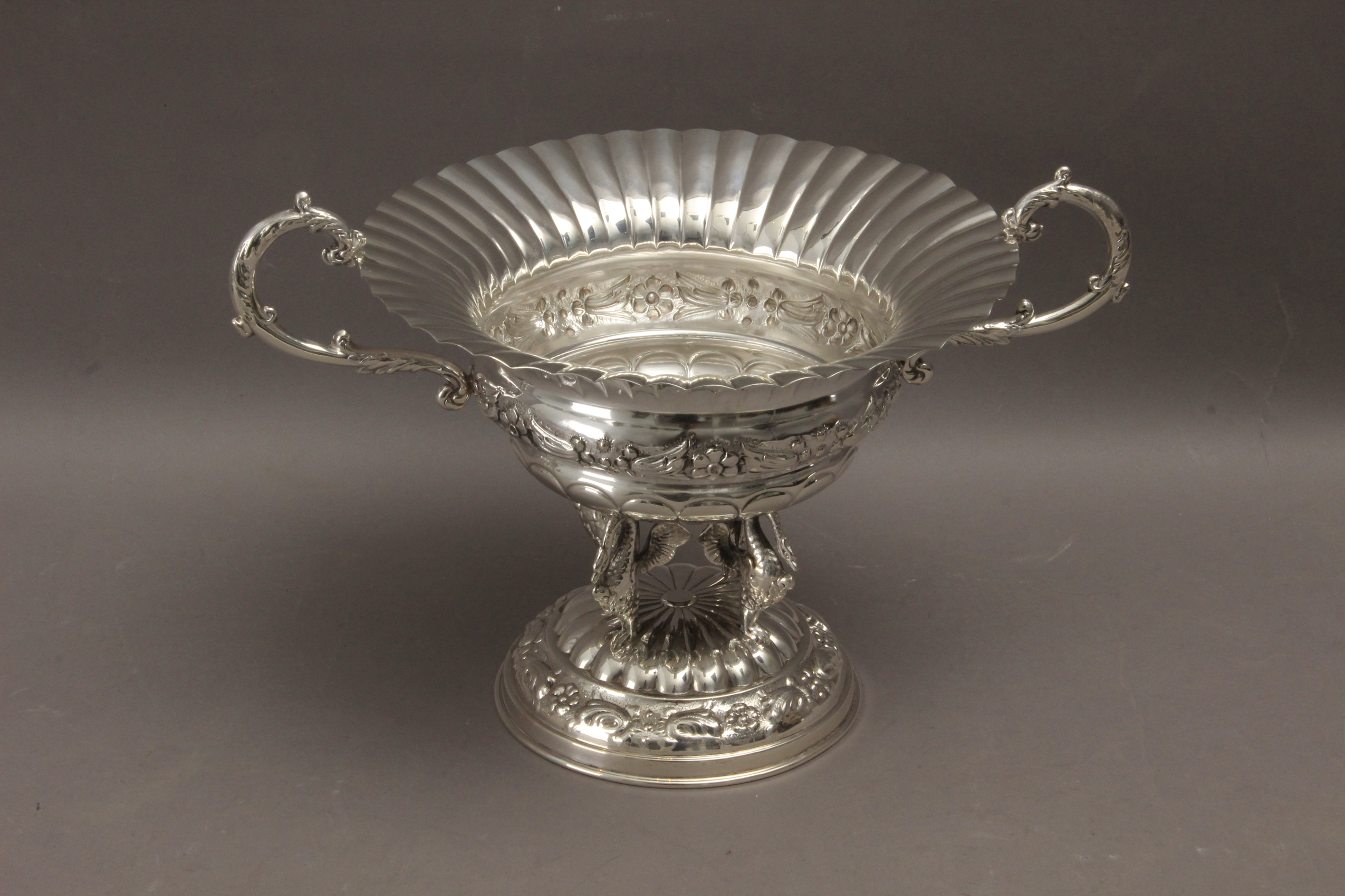 A 20th century Empire style embossed silver centrepiece