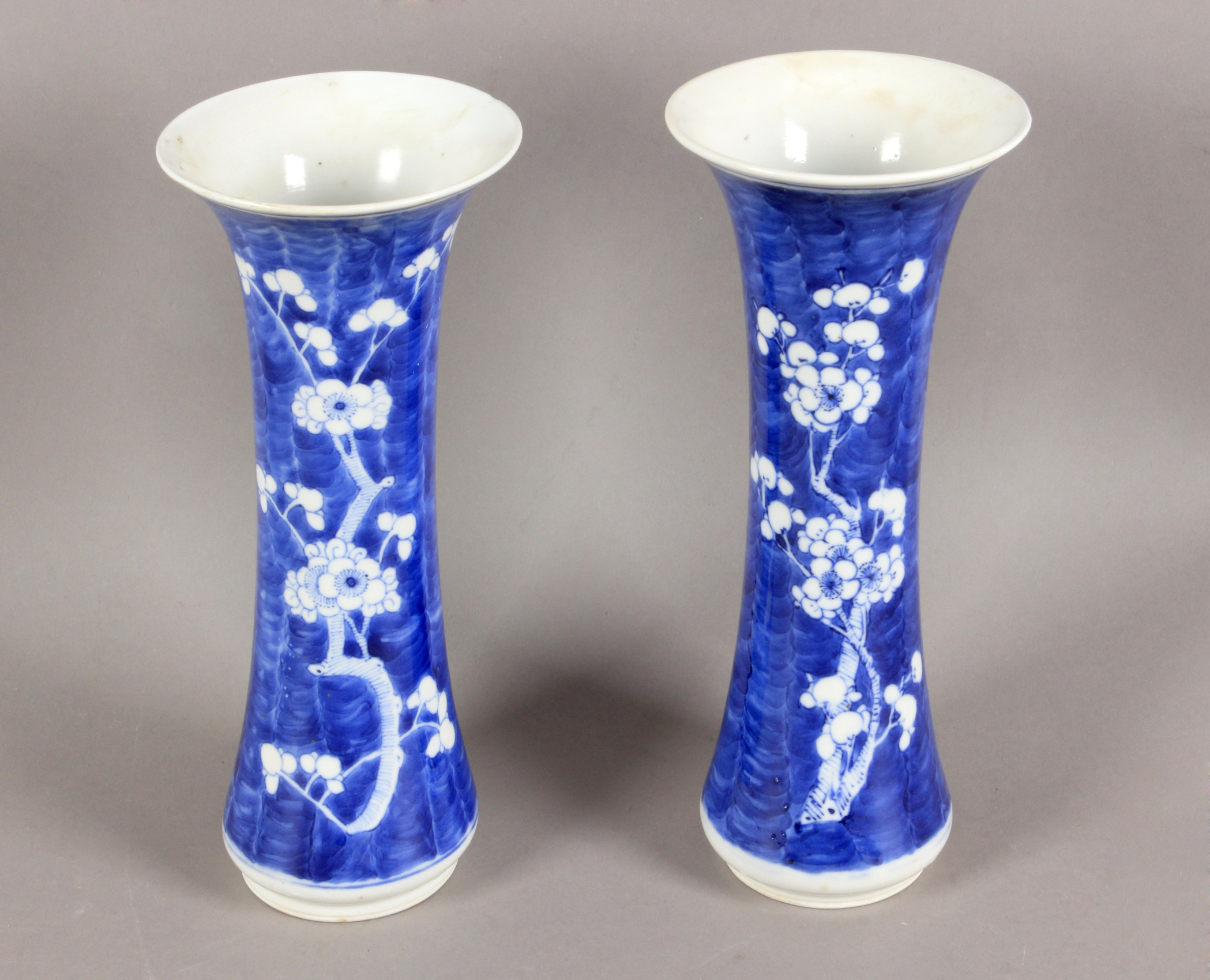 A pair of 19th century Chinese trumpet vases in white and blue porcelain
