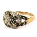 A braided ring with an 18 k. yellow gold and silver setting with single cut diamonds