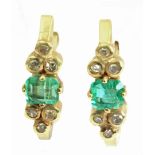 A pair of emerald and diamond earrings with an 18k. yellow gold setting