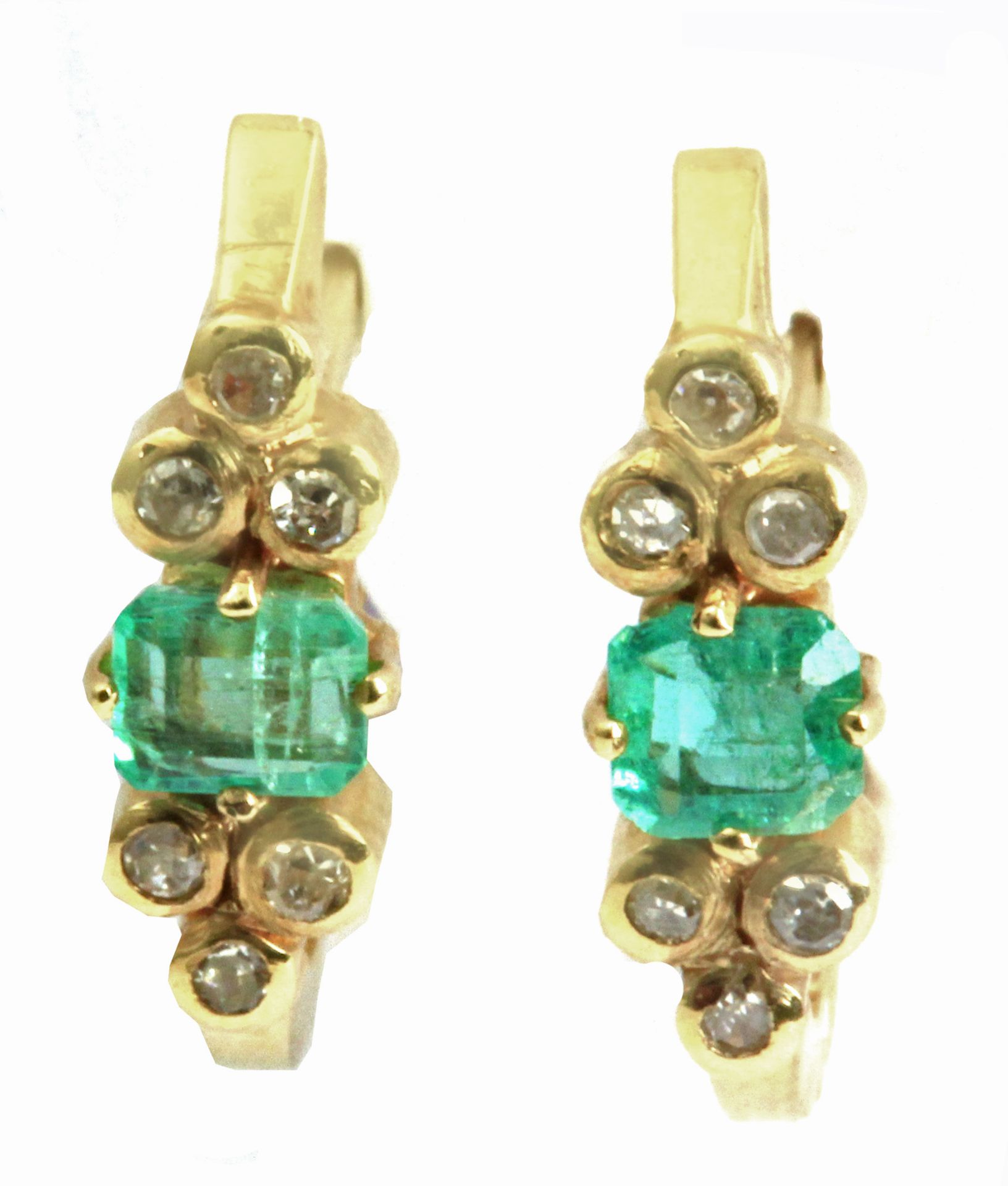 A pair of emerald and diamond earrings with an 18k. yellow gold setting
