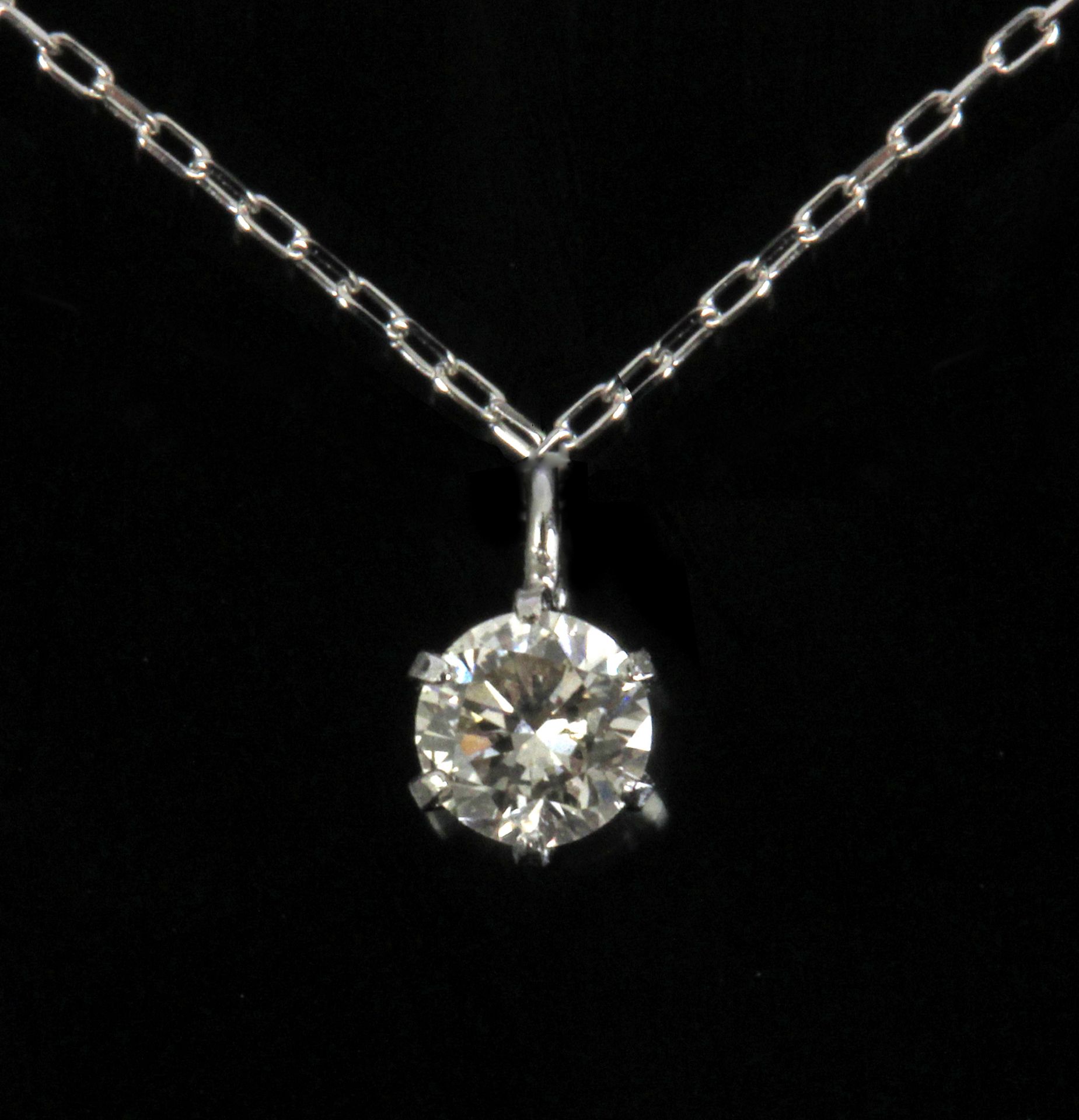 A 0,10 ct. round brilliant cut diamond pendant with a platinum setting and chain