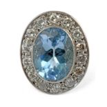 A blue topaz cluster ring with a platinum setting and round brilliant cut diamonds