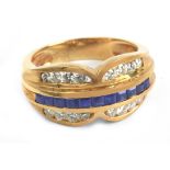 An 18 k. yellow gold ring with round brilliant cut diamonds and carre cut sapphires