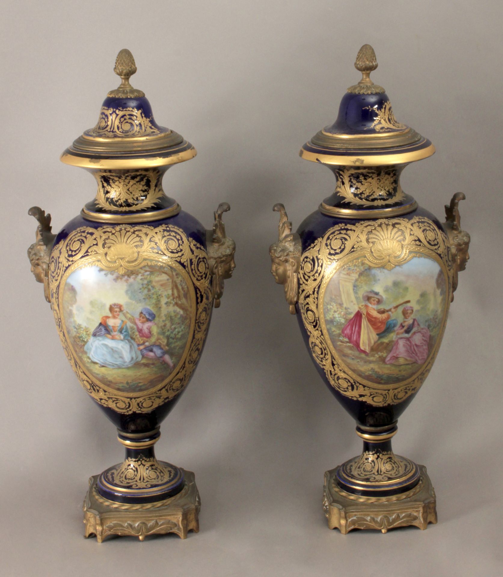 A pair of 18th century French vases and covers in Sévres porcelain garnished with gilt bronze
