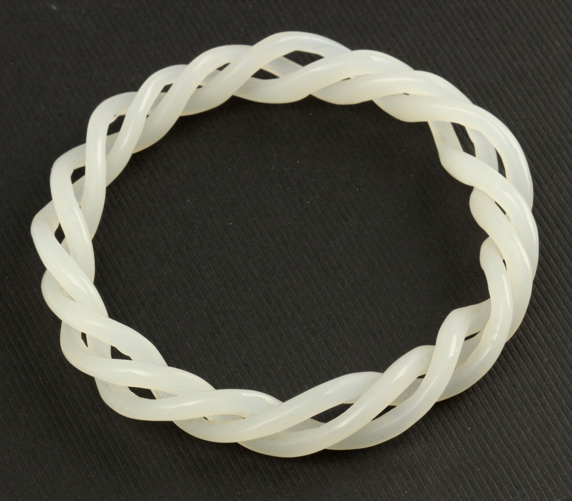 A 20 th century white jade twist bangle