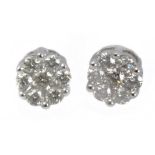 A pair of stud earrings with an 18 k. white gold setting and round brilliant cut diamonds
