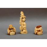 20th century Japanese school. A pair of netsukes and a figure in carved ivory