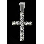 A pendant cross with an 18 k. white gold setting and round brilliant cut diamonds