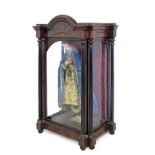 A 19th century Isabelino mahogany glass cabinet with a religious santos cage doll of the Virgin