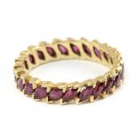 An eternity ring with an 18 k. yellow gold and marquise cut rubies