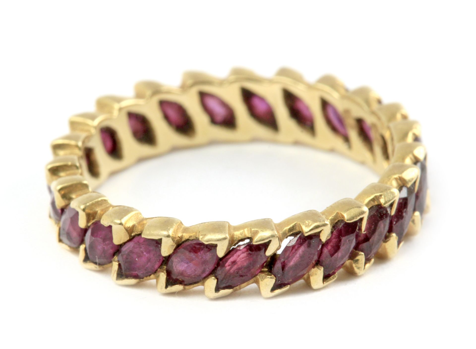 An eternity ring with an 18 k. yellow gold and marquise cut rubies