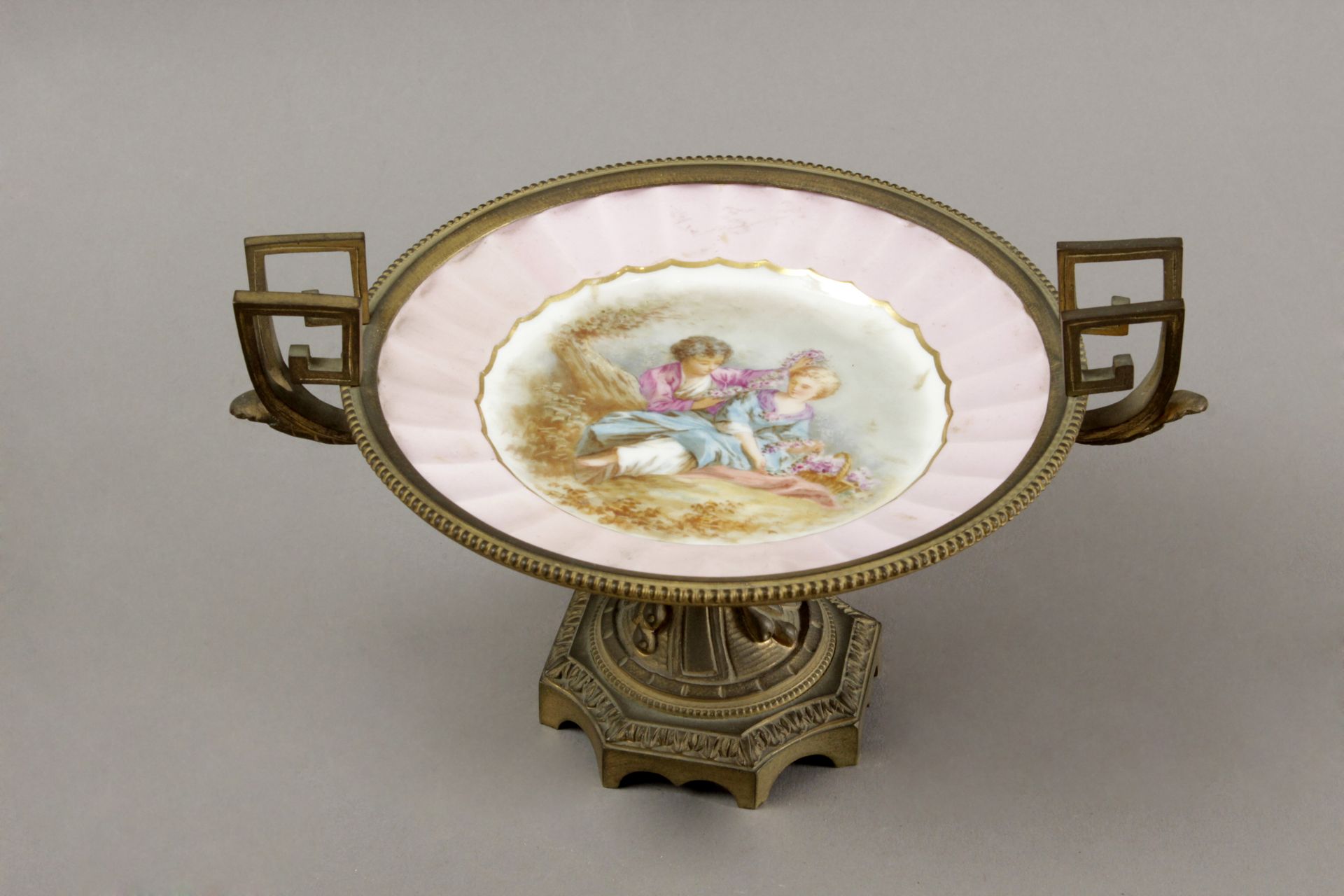 A late 19th century French gilt bronze centrepiece with a Sévres porcelain plate
