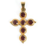 A pendant cross with an 18k. yellow gold setting and round brilliant cut almandine garnets