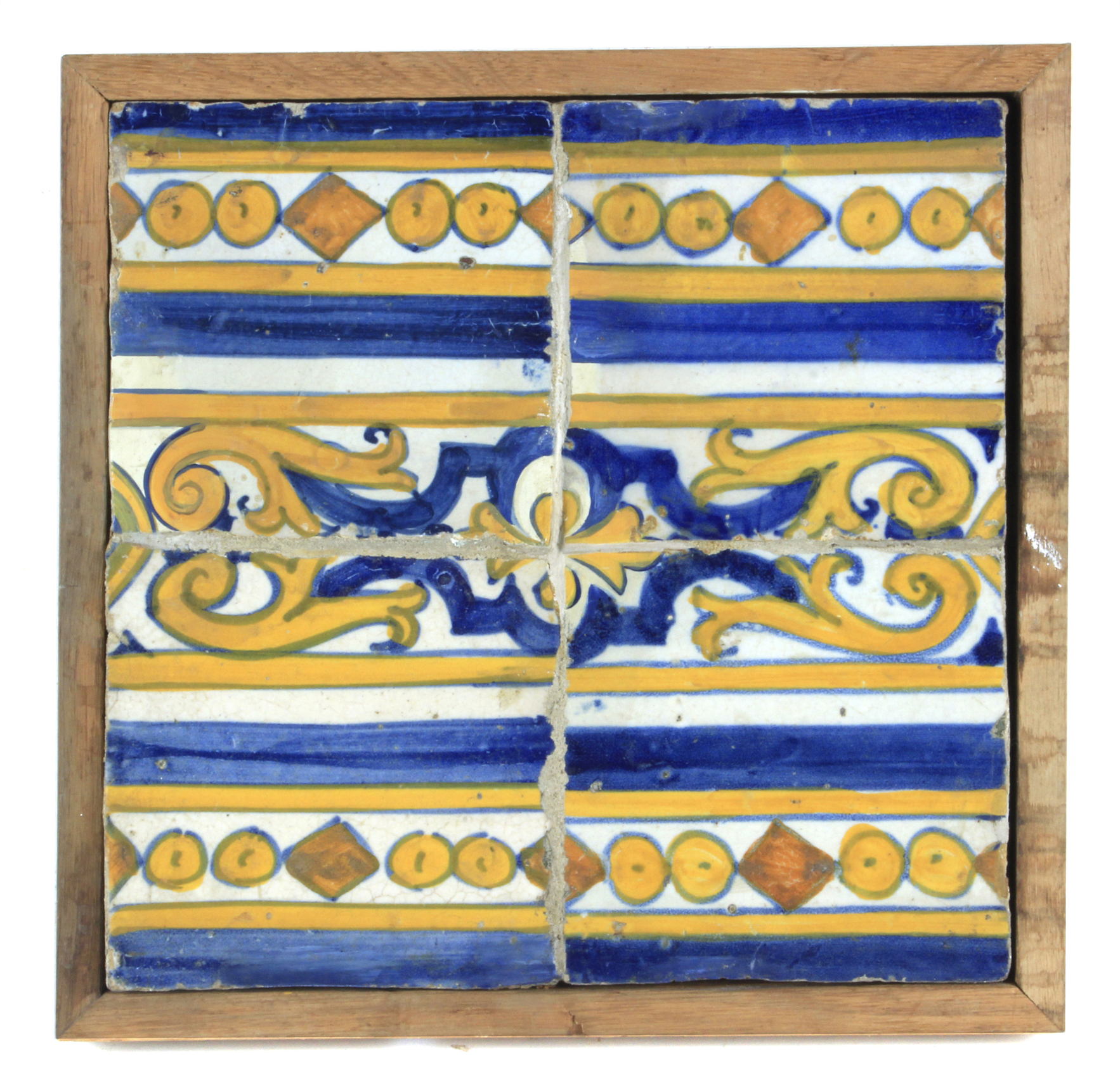 An 18th century plaque with four showing tiles from Portugal or Talavera