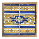 An 18th century plaque with four showing tiles from Portugal or Talavera