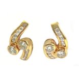 A pair of earrings with an 18 k. yellow gold and round brilliant cut diamonds