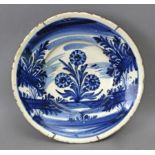 An 18th century Catalan plate in 'faixes i cintes' polychromed pottery