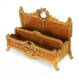 A 19th century French Empire period walnut and gilt bronze letter rack