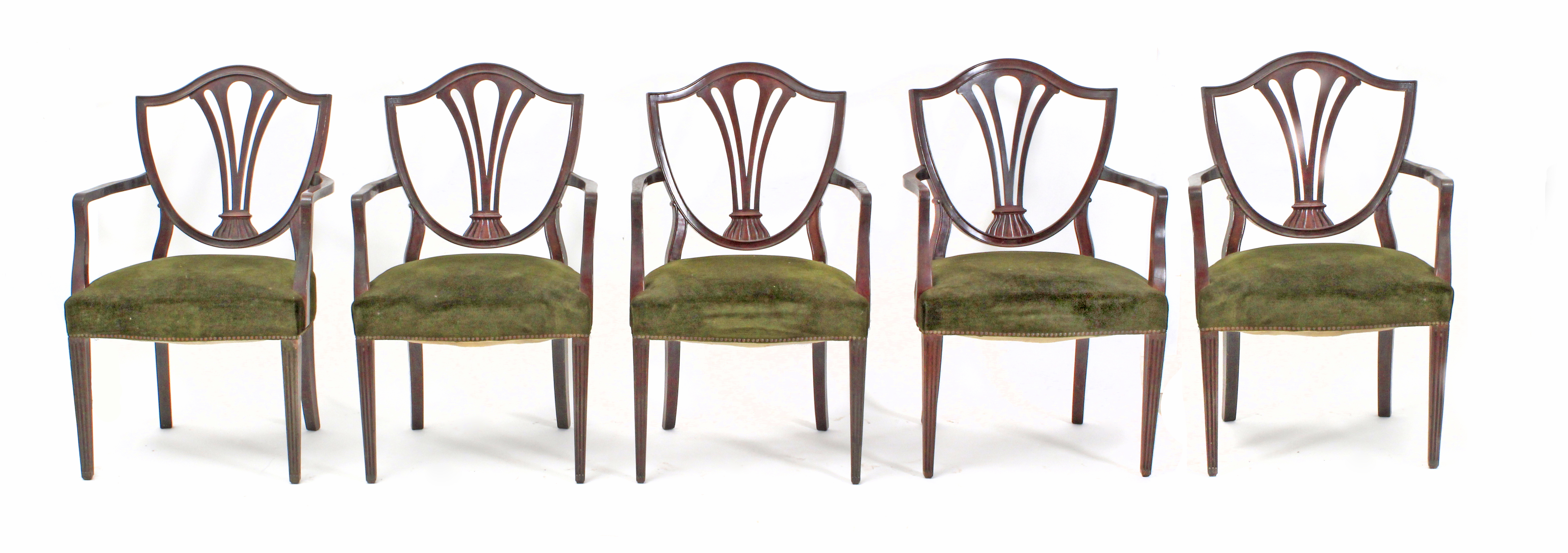 A set of five early 20th century modernist mahogany armchairs with green velvet upholstery