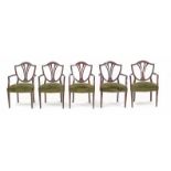 A set of five early 20th century modernist mahogany armchairs with green velvet upholstery