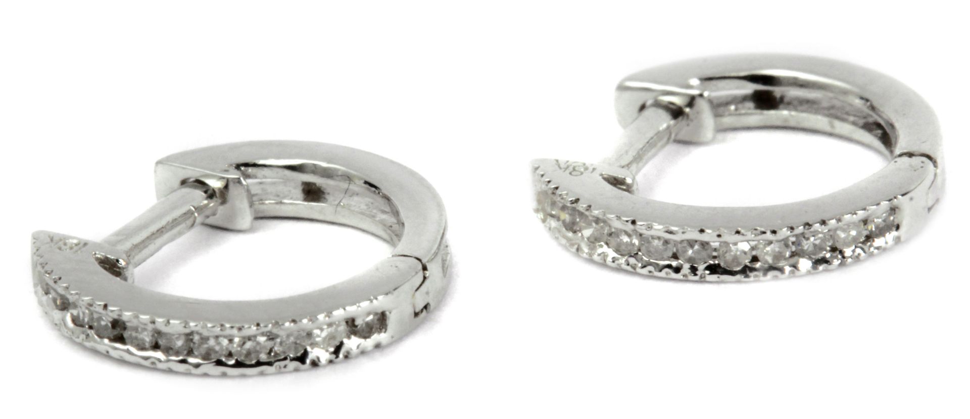 A pair of hoop earrings with an 18 k. white gold setting and round brilliant cut diamonds