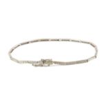 A tennis bracelet with an 18 k. white gold setting and single cut diamonds