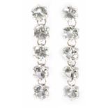 A pair of long earrings with a platinum setting and colourless sapphires
