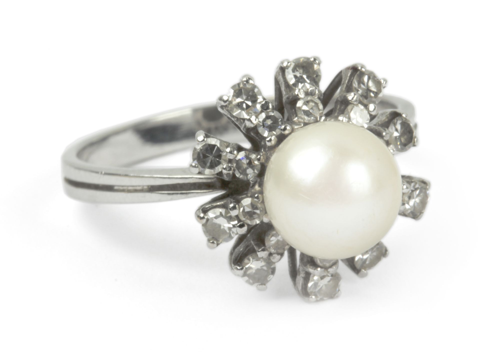 A diamond and pearl cluster ring with an 18 k. white gold setting