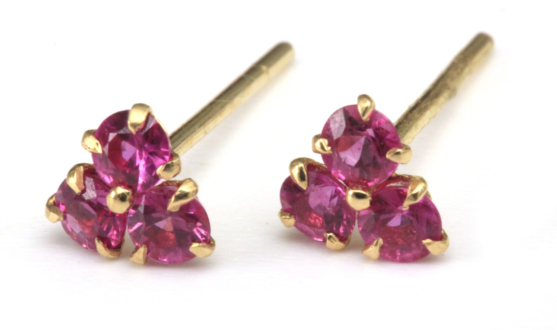 A pair of ruby earrings with an 18 k. yellow gold setting