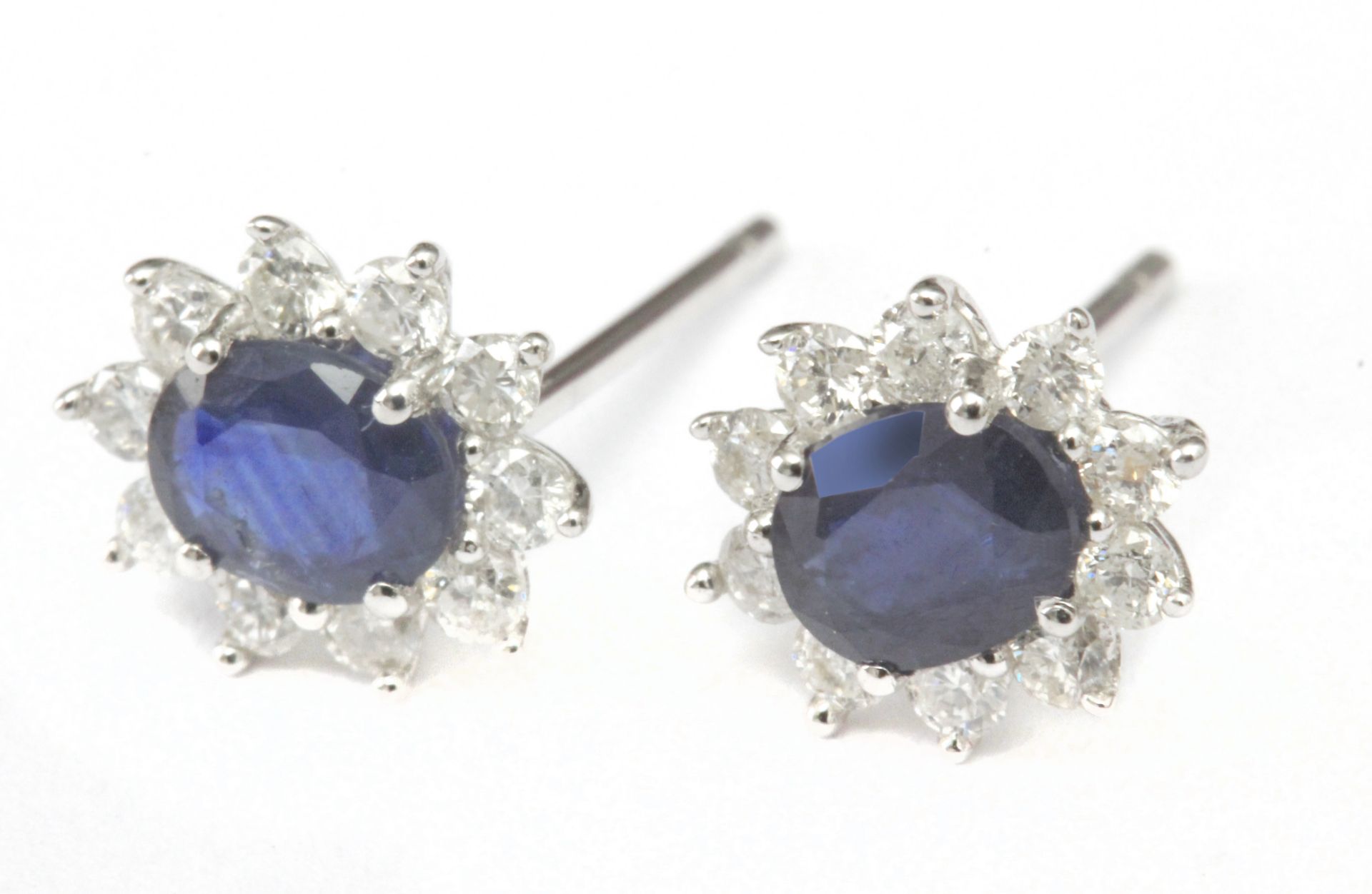 A pair of sapphires and diamond cluster earrings with an 18 k. white gold setting