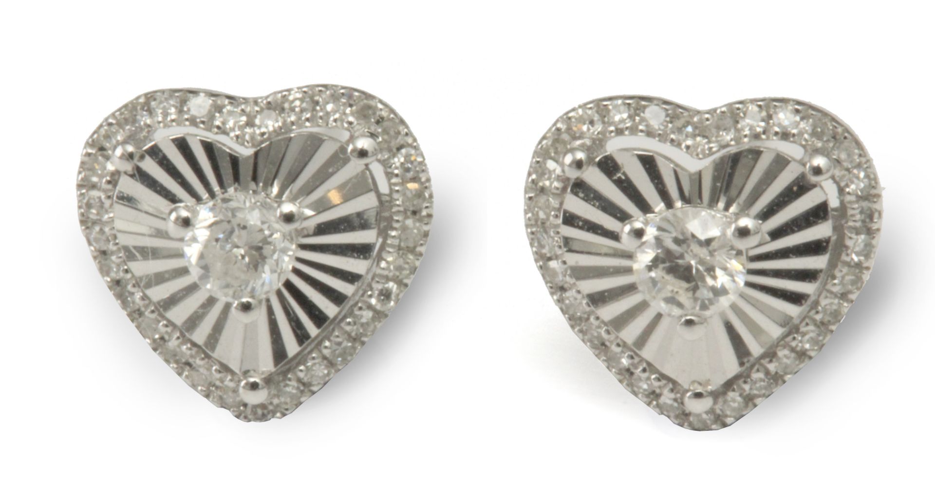 A pair of diamond heart shaped stud earrings with an 18 k. white gold setting