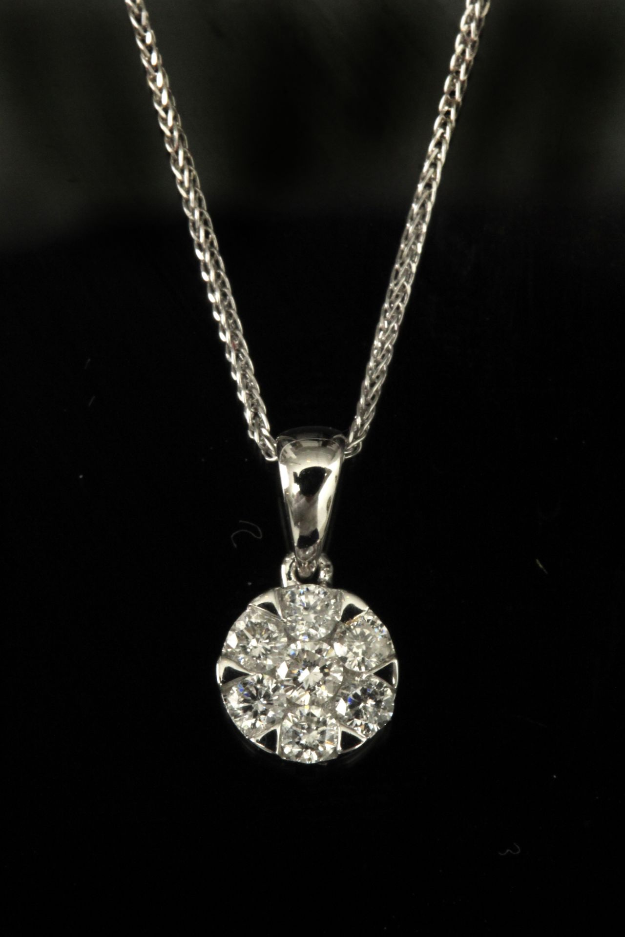 A brilliant cut diamonds cluster pendant with an 18 k. white gold setting and chain