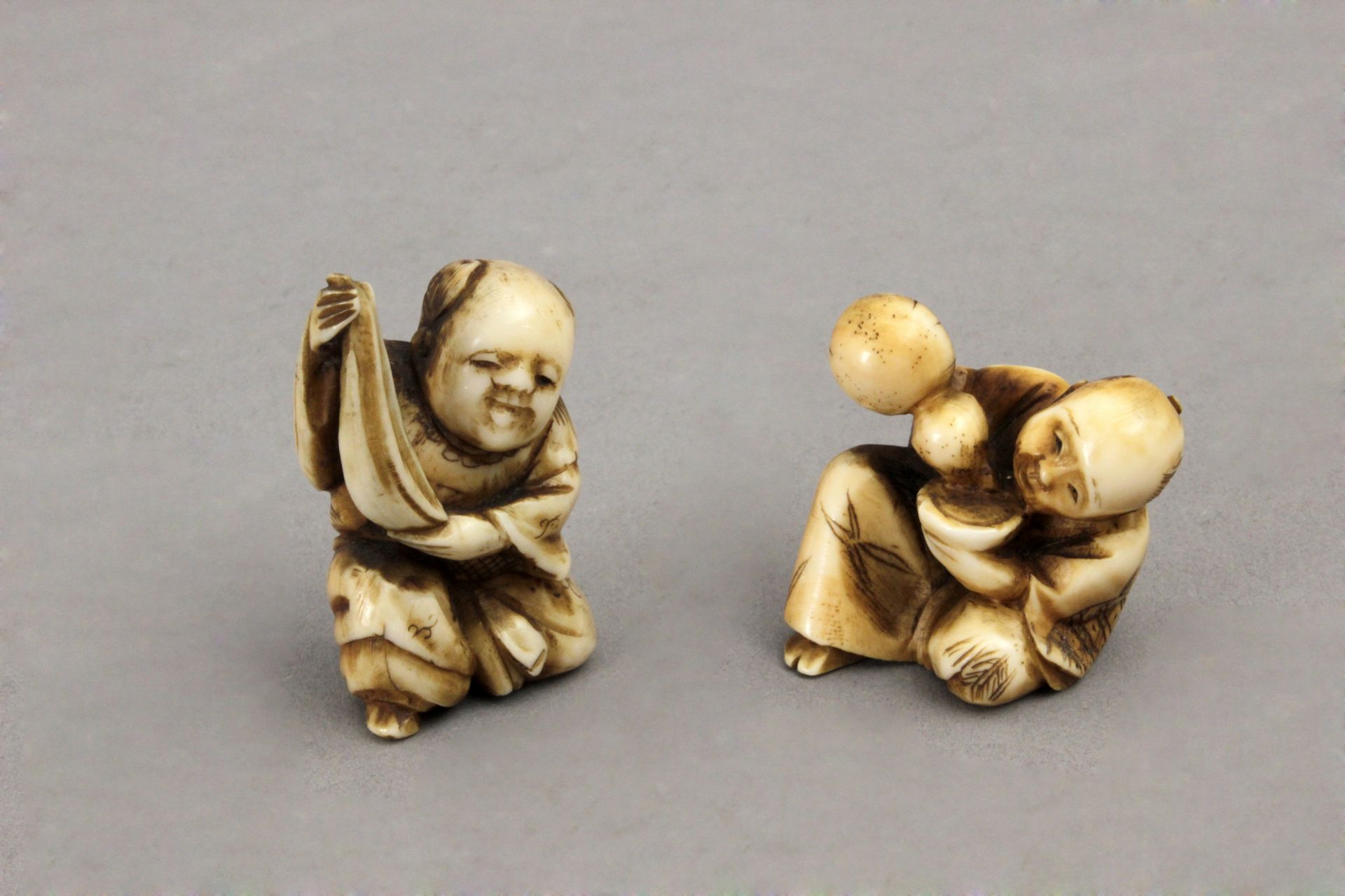 A late 19th century Japanese school. Two Meiji netsukes in carved ivory