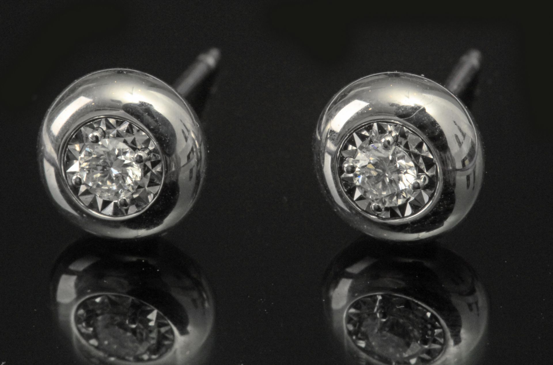 A pair of brilliant cut diamonds stud earrings with an 18 k. white gold setting