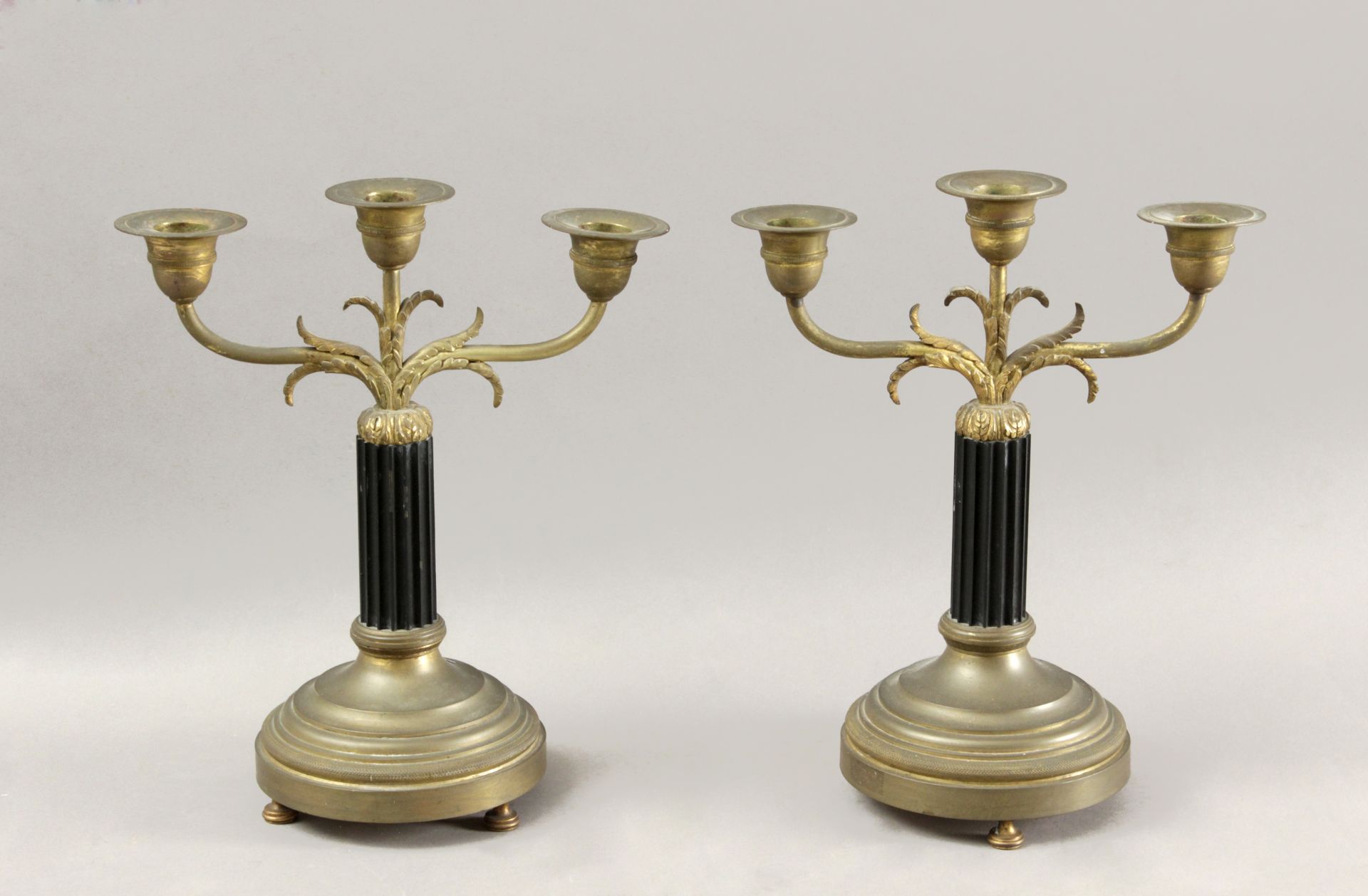 A pair of late 19th century Napoleon III bronze candlesticks